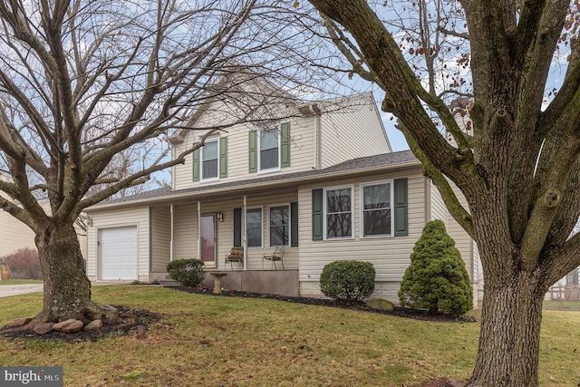 view of front facade with a front yard and a garage