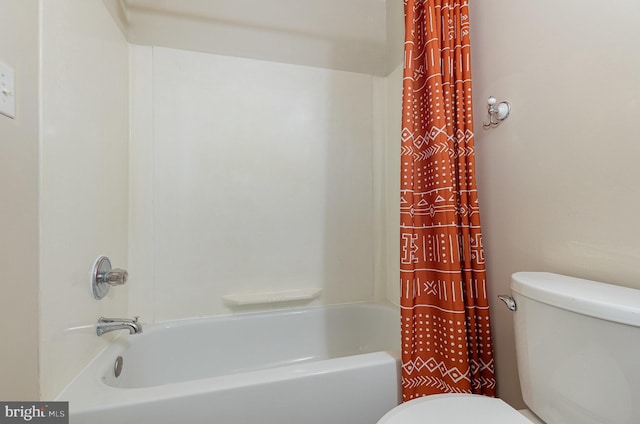 full bathroom featuring shower / bath combination with curtain and toilet