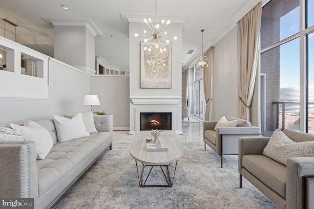 living room with a wealth of natural light, a chandelier, and ornamental molding