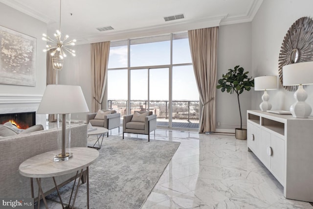 living room with a high end fireplace, crown molding, and a notable chandelier