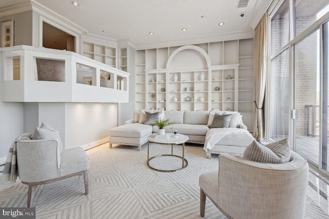 living room featuring built in shelves and ornamental molding