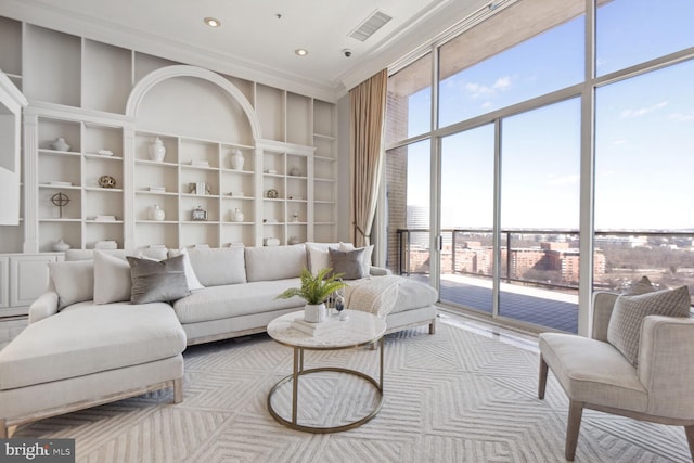 living room featuring a wealth of natural light and ornamental molding