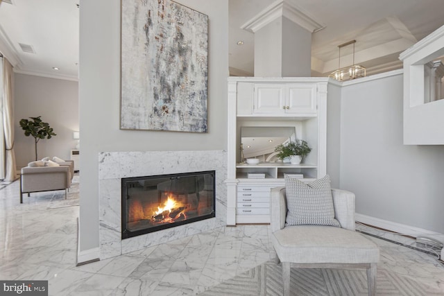 living area featuring a fireplace and ornamental molding