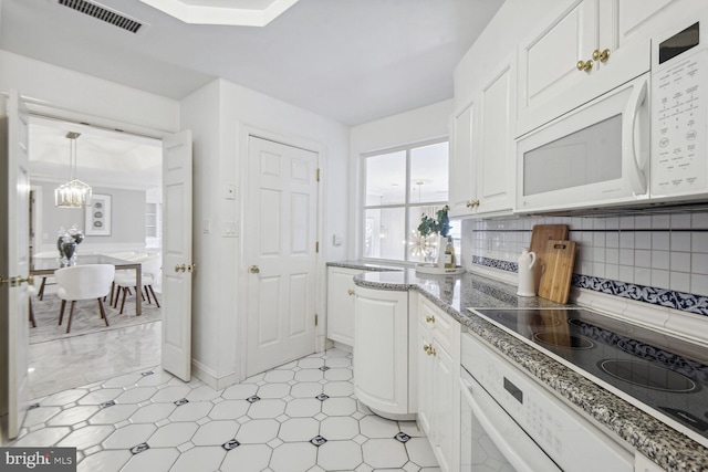1401 N Oak St Unit 903, 905, Arlington, VA 22209 - kitchen featuring white microwave, white cabinets, oven, and decorative backsplash
