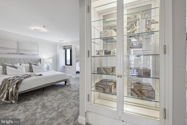 carpeted bedroom featuring crown molding