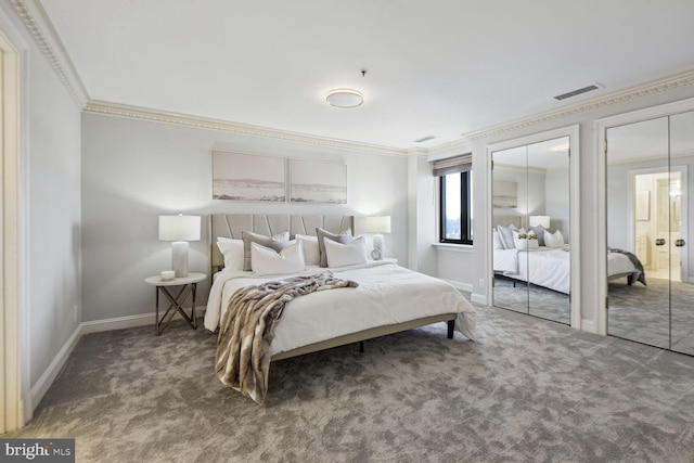 carpeted bedroom featuring two closets and crown molding