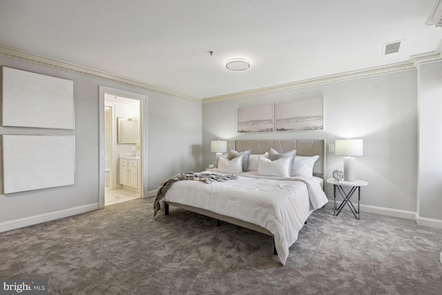 bedroom with carpet floors, crown molding, and connected bathroom