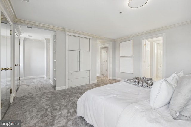 bedroom featuring carpet flooring, connected bathroom, and crown molding