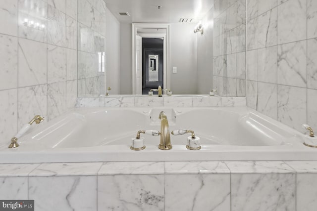 bathroom with tiled bath