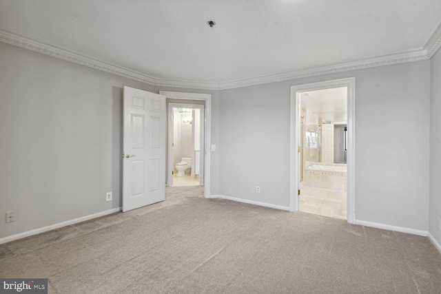 unfurnished bedroom featuring ornamental molding, light carpet, and connected bathroom