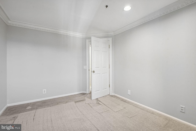 empty room featuring light carpet and ornamental molding