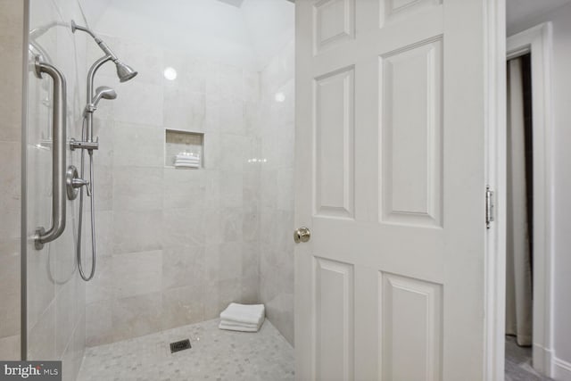 bathroom with tiled shower