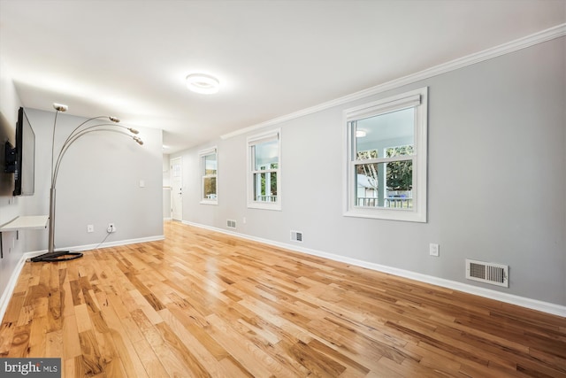 interior space with wood-type flooring and ornamental molding