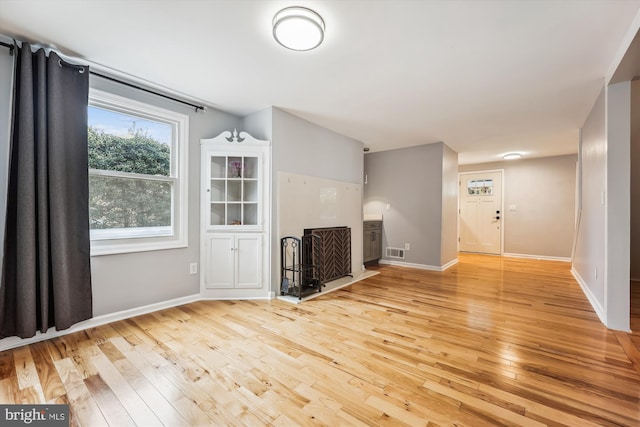 unfurnished living room with light hardwood / wood-style floors