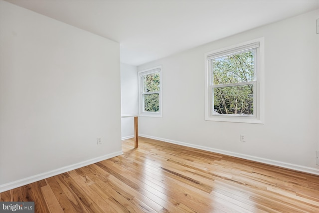 unfurnished room with light hardwood / wood-style flooring