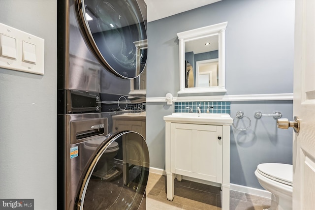 bathroom featuring backsplash, tile patterned floors, vanity, and toilet