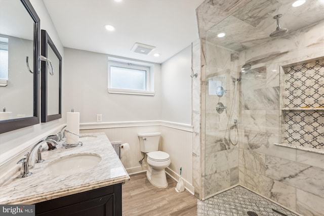 bathroom with an enclosed shower, vanity, toilet, and wood-type flooring