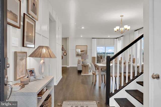 entryway with a chandelier and dark hardwood / wood-style floors