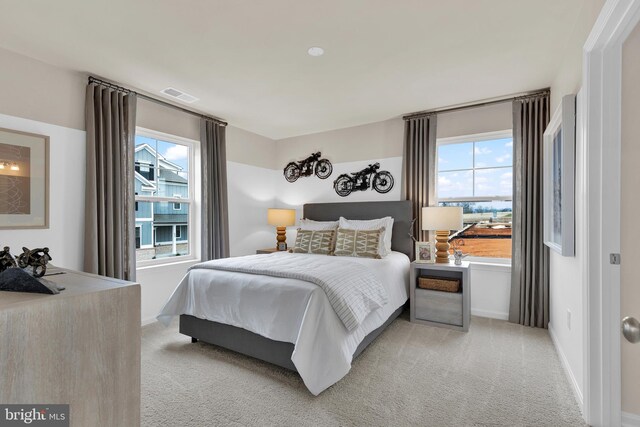 bedroom featuring light colored carpet