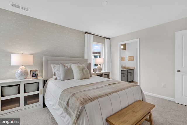 carpeted bedroom featuring connected bathroom