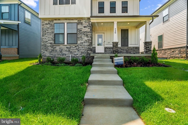 exterior space featuring covered porch and a lawn