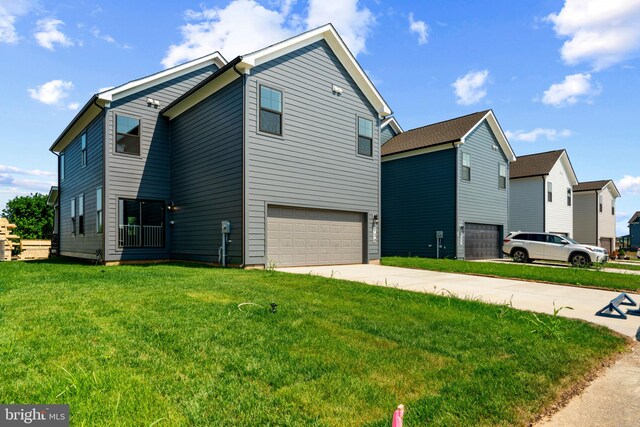 view of side of home with a lawn and a garage