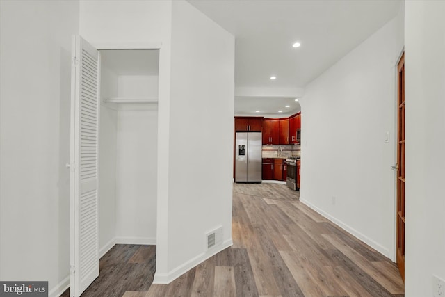 hall with hardwood / wood-style flooring