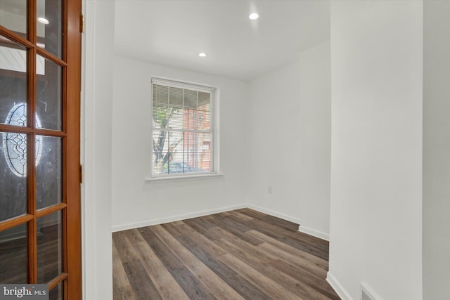 spare room with dark hardwood / wood-style flooring