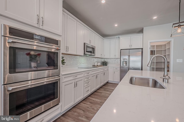 kitchen featuring white cabinets, sink, and appliances with stainless steel finishes