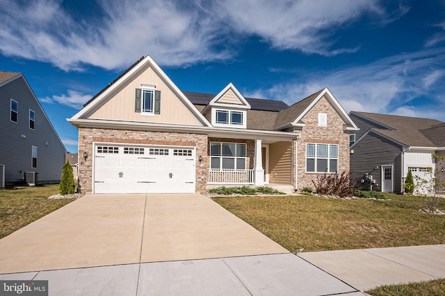 craftsman-style house with solar panels, a garage, covered porch, and a front lawn