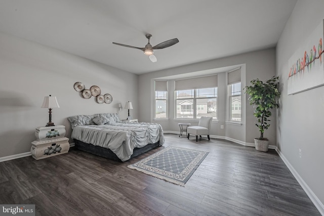 bedroom with ceiling fan and dark wood-type flooring