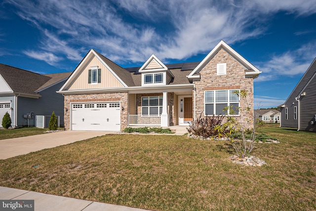 craftsman inspired home with solar panels, a porch, and a front lawn