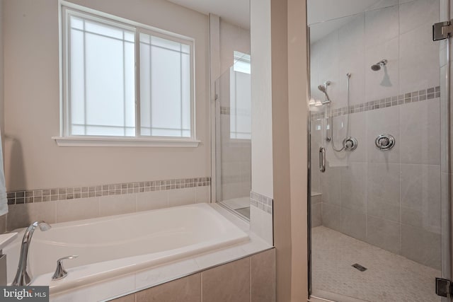 bathroom featuring plus walk in shower