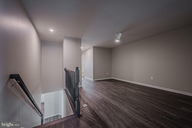 interior space with ceiling fan and dark wood-type flooring