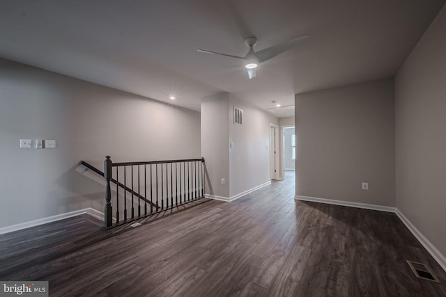 spare room with ceiling fan and dark hardwood / wood-style floors