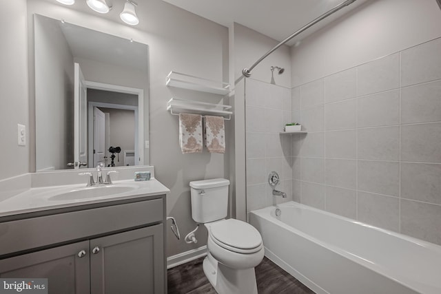 full bathroom featuring toilet, hardwood / wood-style floors, vanity, and tiled shower / bath