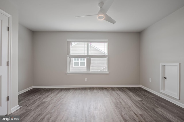 unfurnished room with dark hardwood / wood-style floors and ceiling fan