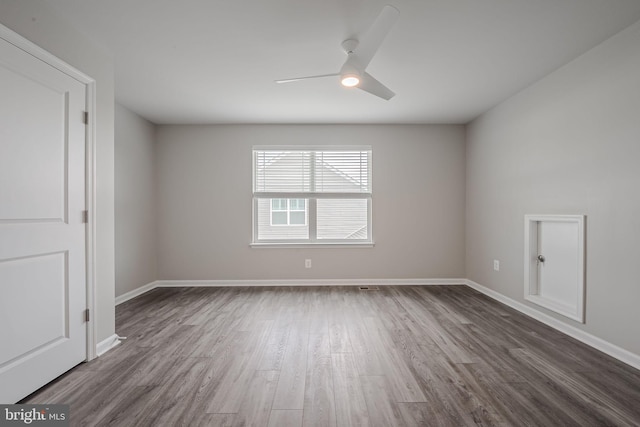 unfurnished room featuring dark hardwood / wood-style flooring and ceiling fan