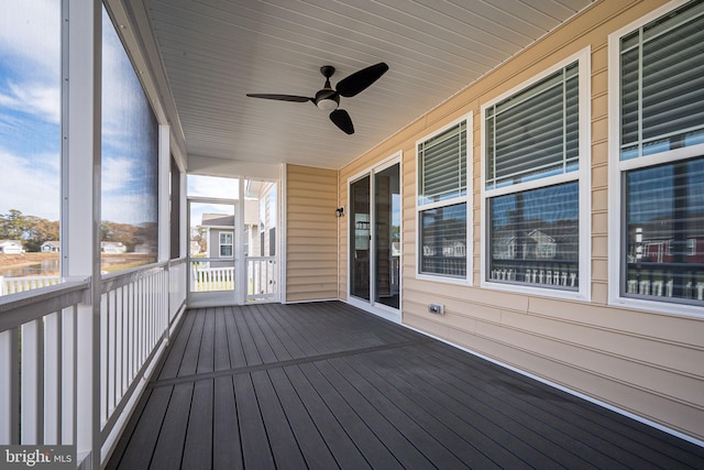 unfurnished sunroom featuring ceiling fan and a healthy amount of sunlight