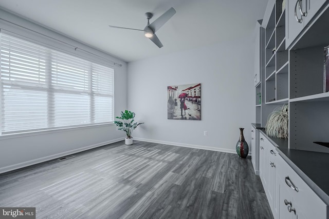 interior space with dark hardwood / wood-style flooring and ceiling fan