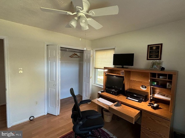 office with hardwood / wood-style flooring and ceiling fan