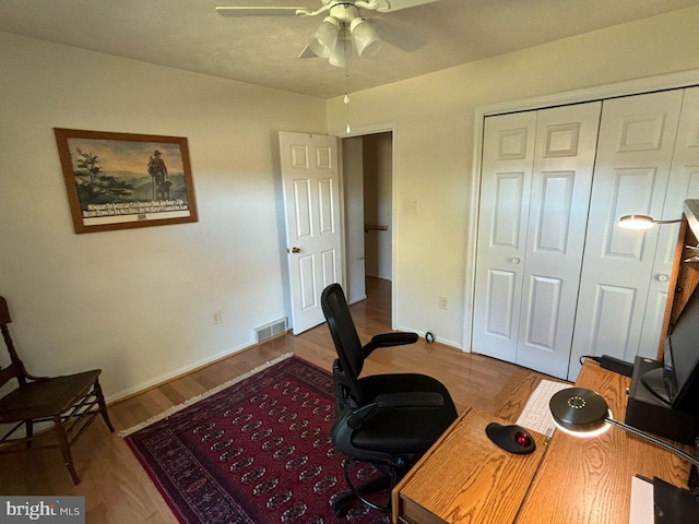 office with hardwood / wood-style floors and ceiling fan