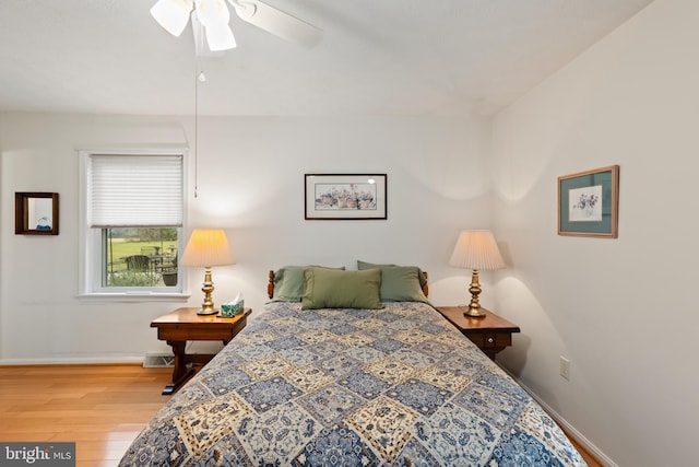 bedroom with ceiling fan and wood-type flooring