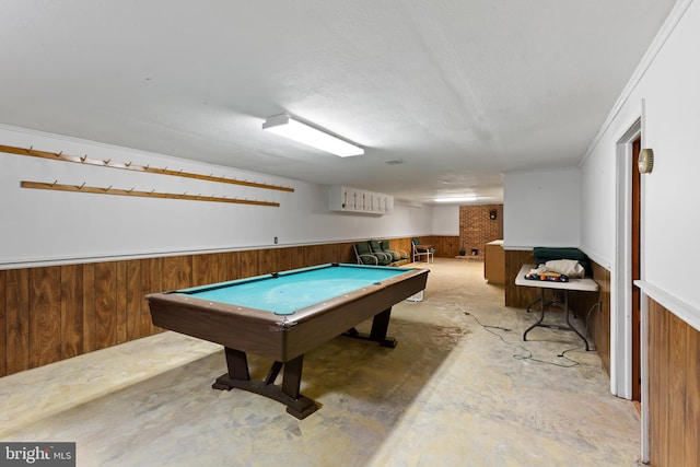 rec room with a textured ceiling, crown molding, wood walls, and billiards