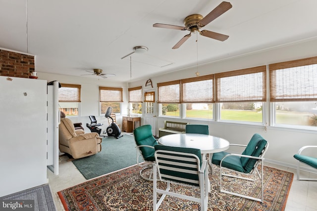 sunroom featuring ceiling fan