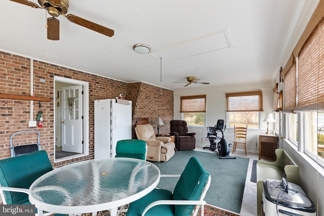 sunroom / solarium with a wealth of natural light and ceiling fan