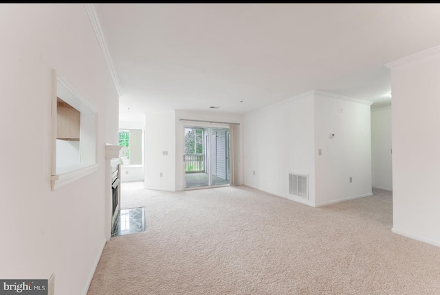 carpeted empty room featuring crown molding