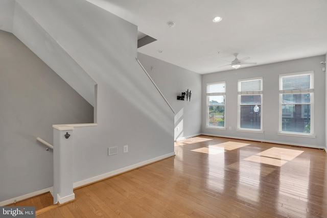 unfurnished living room with ceiling fan and light hardwood / wood-style floors