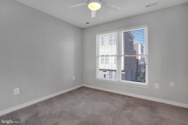 empty room featuring carpet floors and ceiling fan