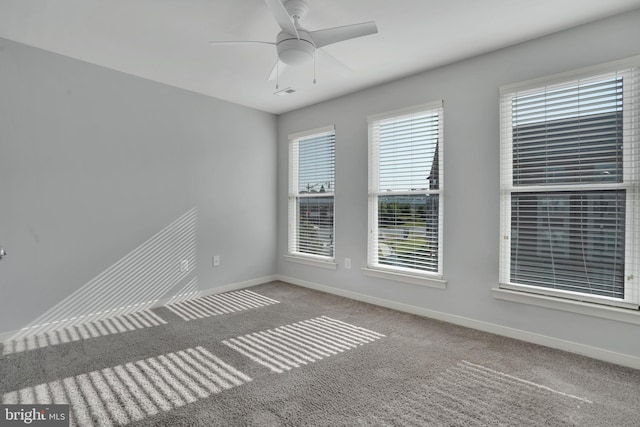 unfurnished room with ceiling fan and light colored carpet